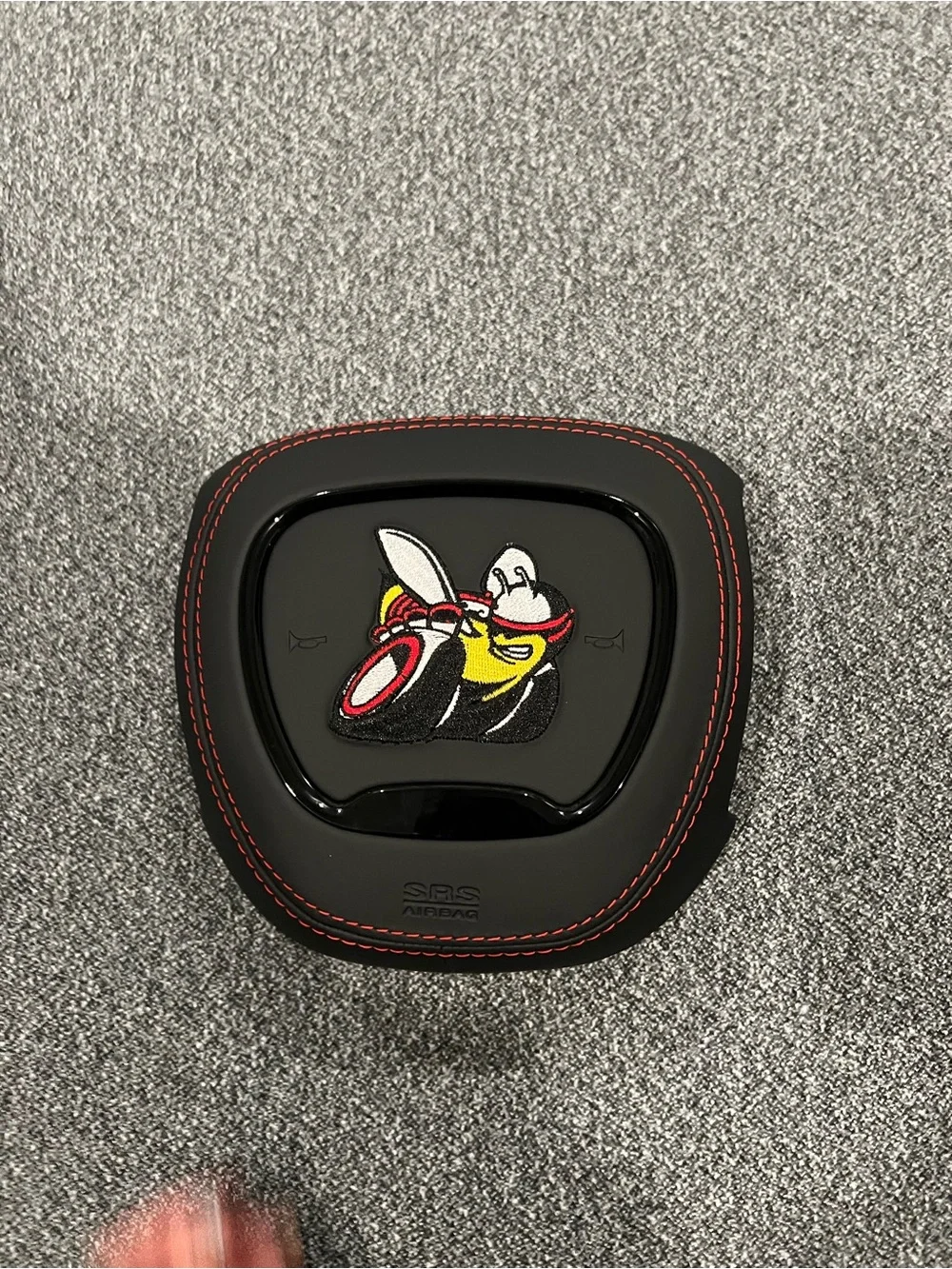 Black Airbag Cover with Red Stitching and Bee Patch